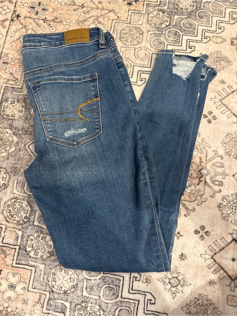 American Eagle Outfitters Medium Blue Skinny Jeans with Distressed Hem